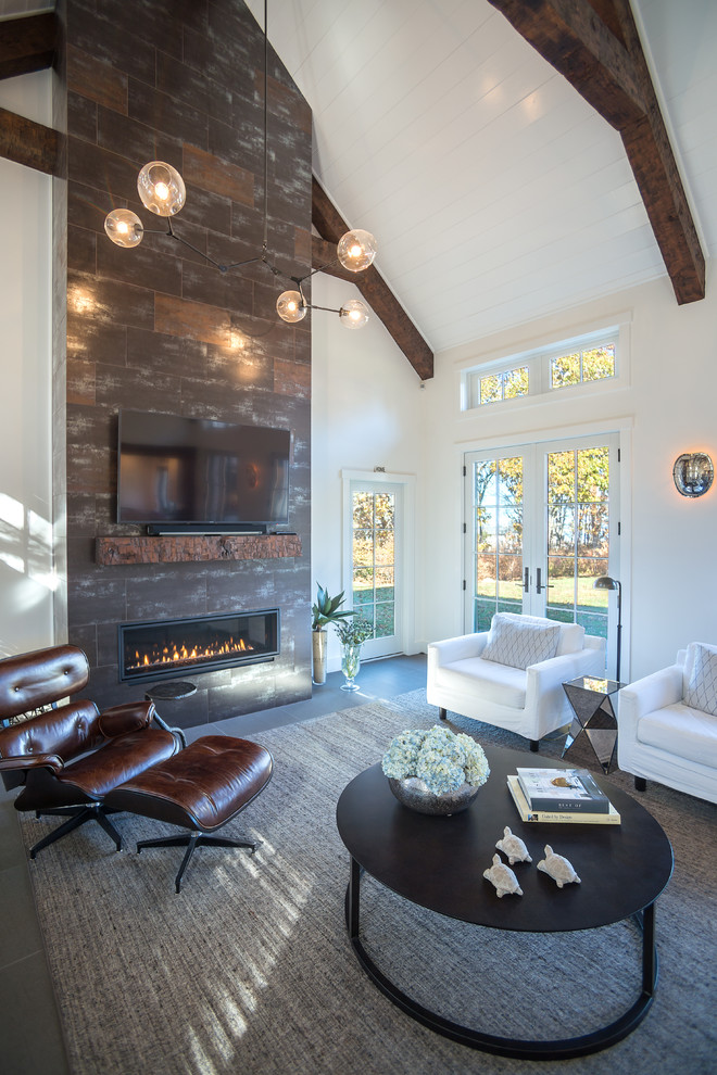 Design ideas for a mid-sized traditional open concept living room in Boston with white walls, porcelain floors, a standard fireplace, a tile fireplace surround, a wall-mounted tv and grey floor.