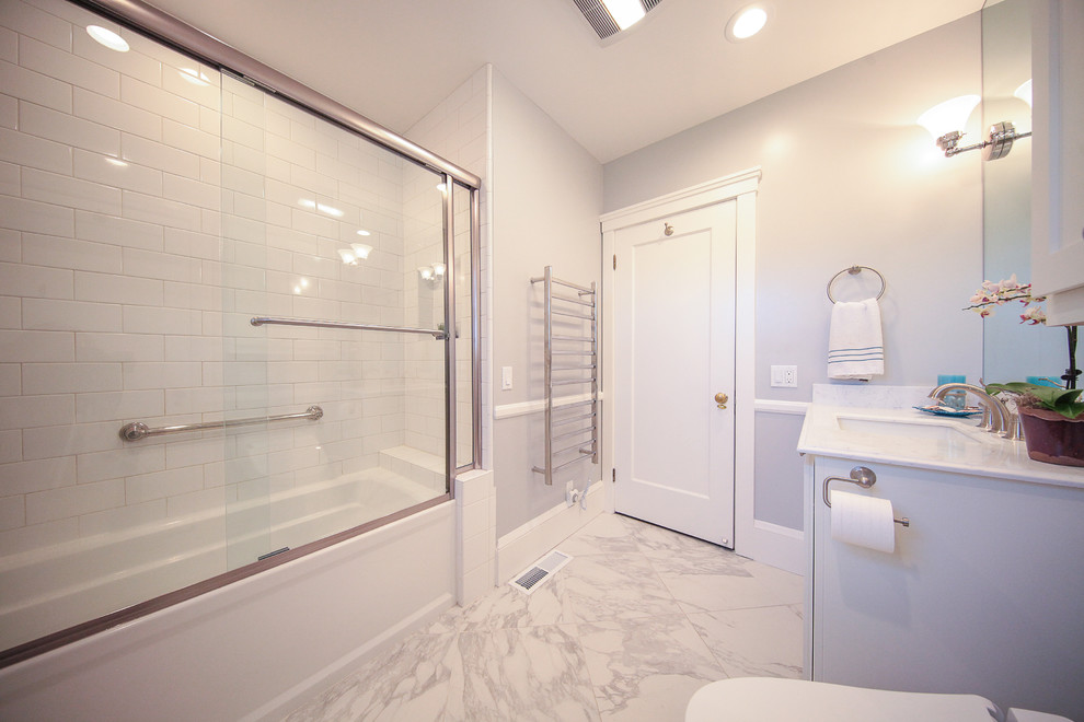 Photo of a mid-sized traditional master bathroom in San Francisco with recessed-panel cabinets, white cabinets, a drop-in tub, a shower/bathtub combo, a bidet, white tile, white walls, linoleum floors and a pedestal sink.