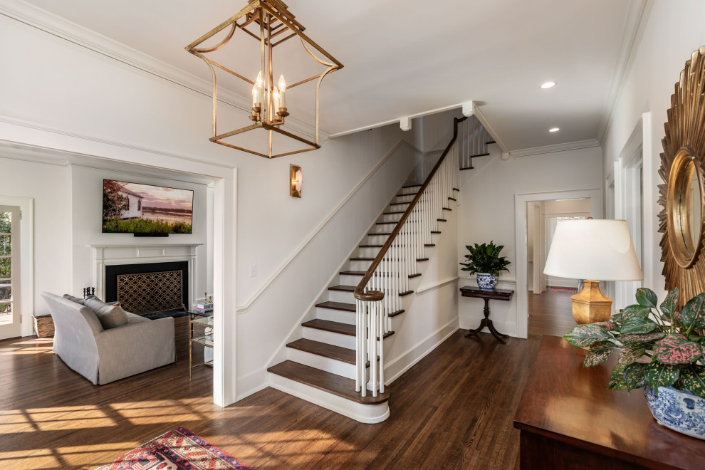 Foyer - large contemporary medium tone wood floor and brown floor foyer idea with white walls and a medium wood front door