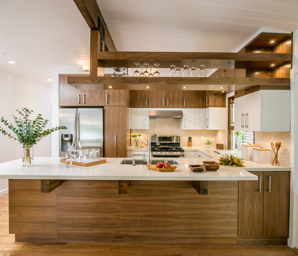 Design ideas for a contemporary u-shaped kitchen in Los Angeles with flat-panel cabinets, medium wood cabinets, beige splashback, stainless steel appliances and a peninsula.