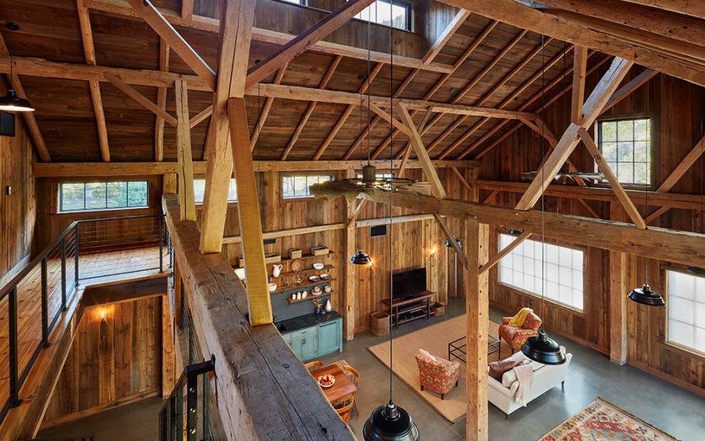Photo of an expansive country mezzanine games room in Boston with exposed beams.