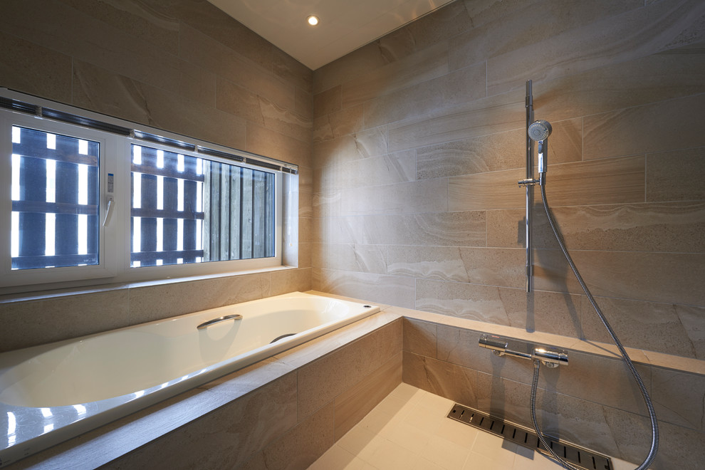 Inspiration for an asian master wet room bathroom with an alcove tub, beige tile, beige walls and beige floor.