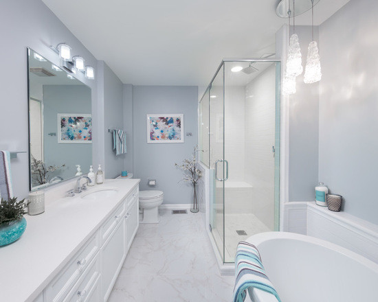 Design ideas for a mid-sized contemporary master wet room bathroom in Chicago with flat-panel cabinets, white cabinets, a drop-in tub, a one-piece toilet, beige walls, marble floors, an undermount sink, engineered quartz benchtops, white floor and a sliding shower screen.