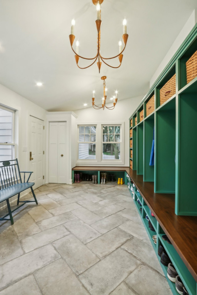 Inspiration for a large transitional limestone floor and gray floor mudroom remodel in Milwaukee with white walls and a white front door