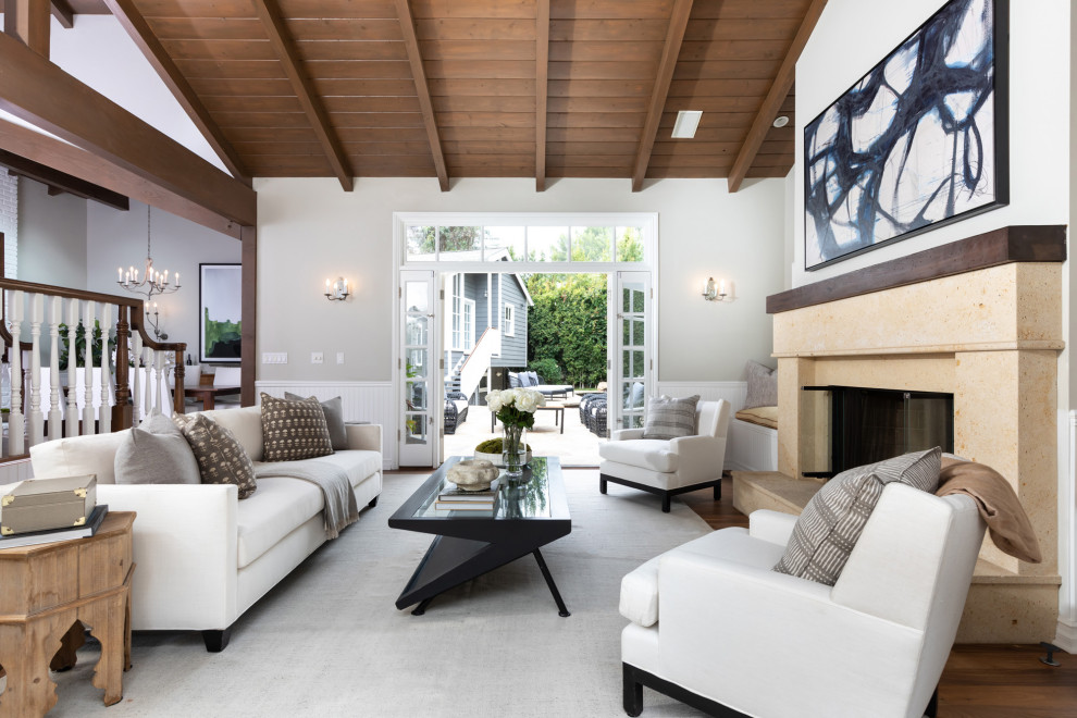 Photo of a large beach style open concept living room in Los Angeles with grey walls, dark hardwood floors, a stone fireplace surround, no tv, brown floor, wood and decorative wall panelling.