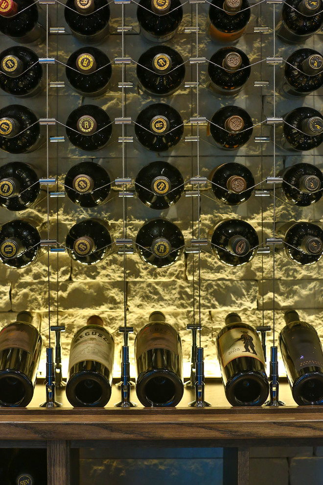 This is an example of a large contemporary wine cellar in Dallas with storage racks.
