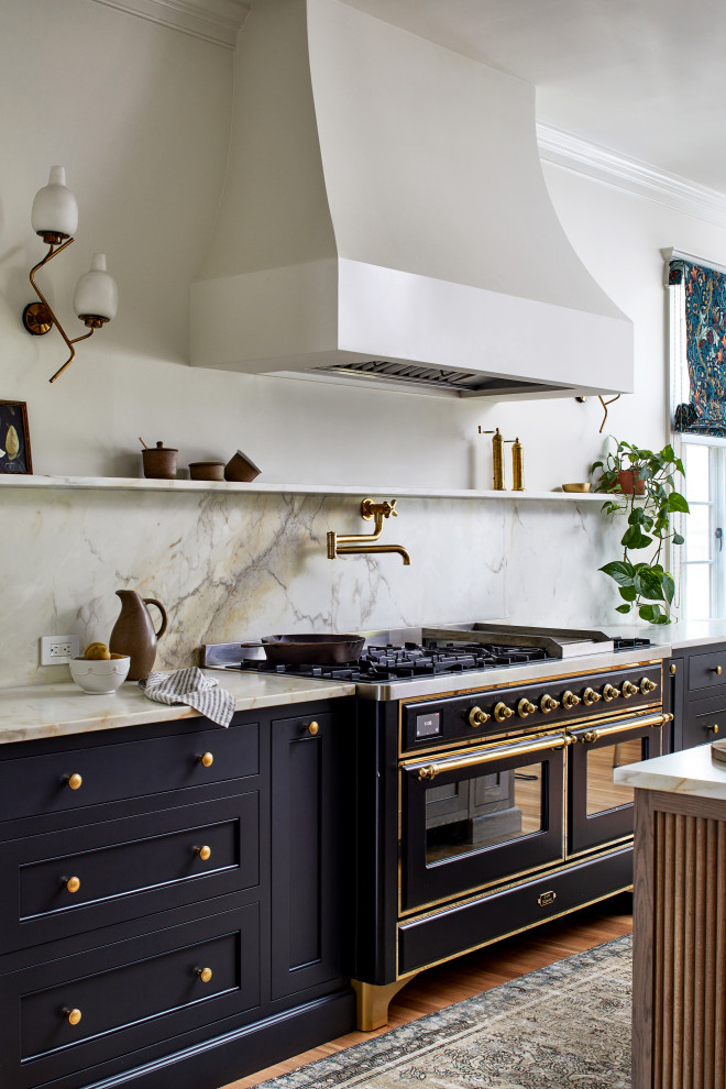 Classic kitchen/diner in DC Metro with a submerged sink, beaded cabinets, black cabinets, marble worktops, marble splashback, black appliances, medium hardwood flooring, an island and beige worktops.