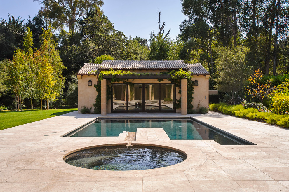 This is an example of a mid-sized mediterranean backyard rectangular pool in San Francisco with a pool house and tile.