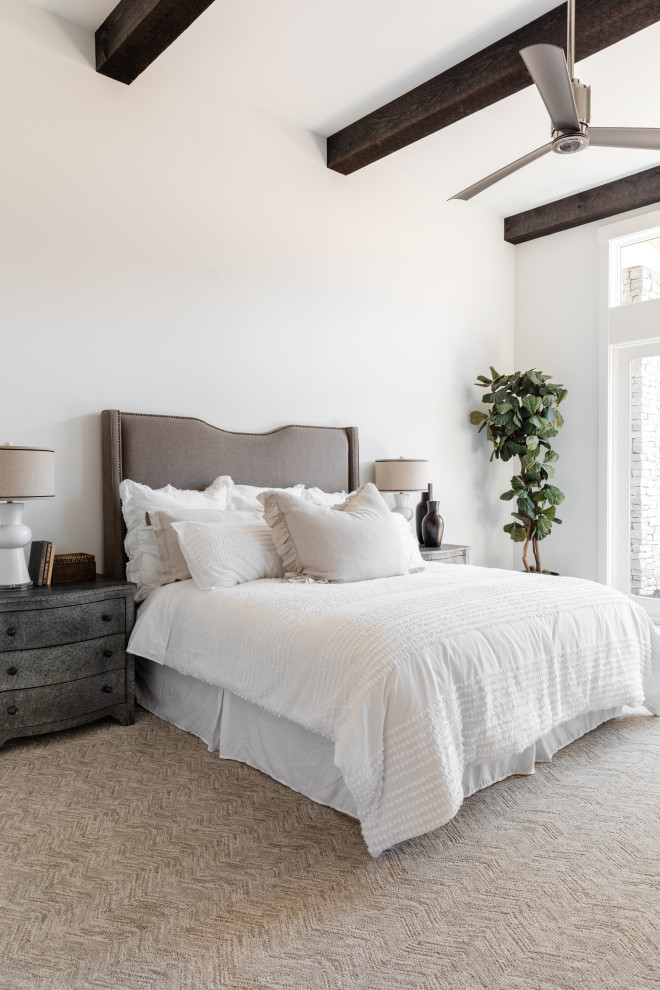 Inspiration for a large mediterranean master bedroom in Sacramento with white walls, carpet and beige floor.