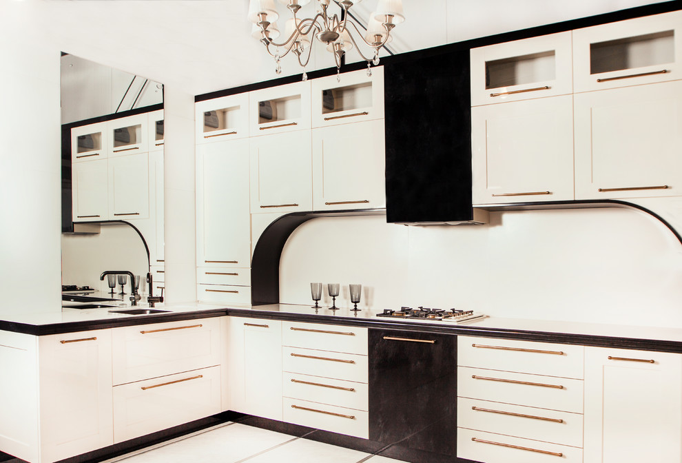 Inspiration for an u-shaped kitchen in Moscow with solid surface benchtops.