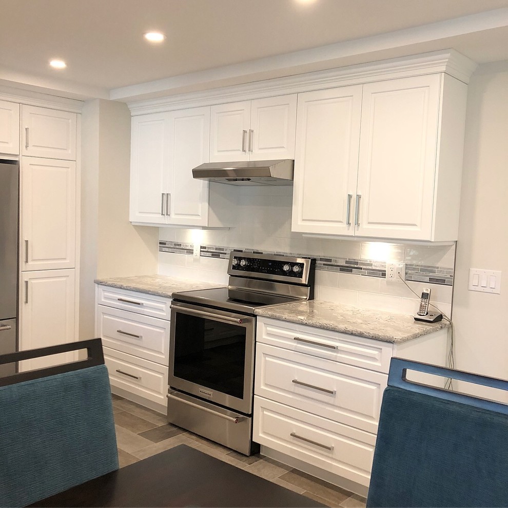 Kitchen - transitional kitchen idea with white cabinets and quartz countertops