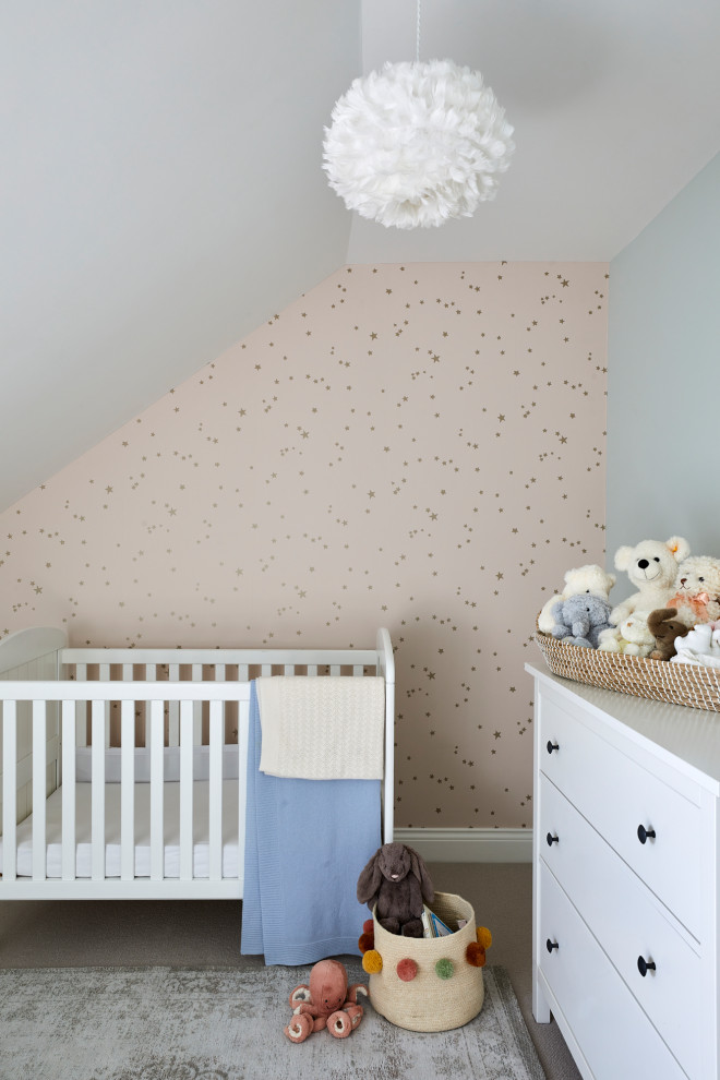 Inspiration for a medium sized traditional nursery in London with green walls, carpet and beige floors.