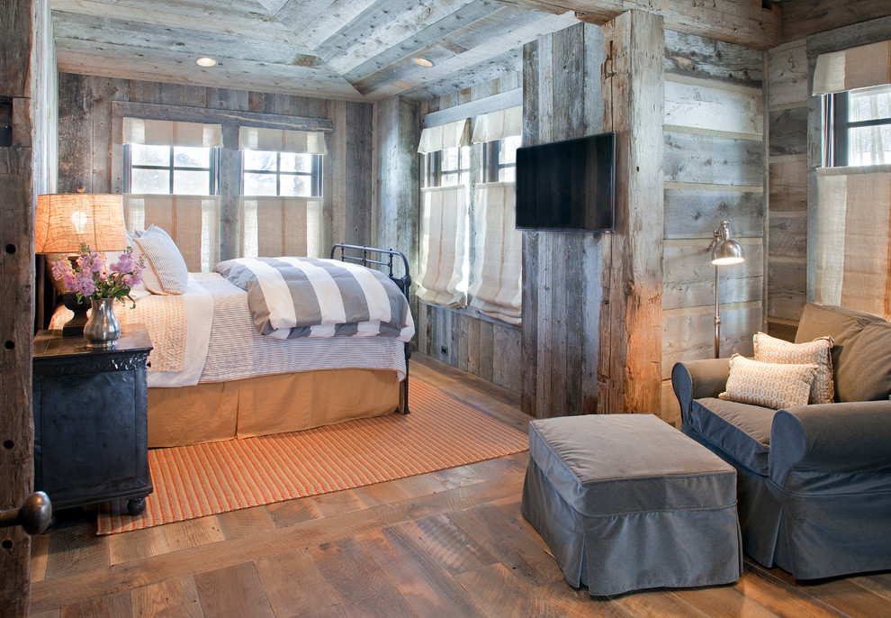 This is an example of a small country guest bedroom in Denver with grey walls and dark hardwood floors.