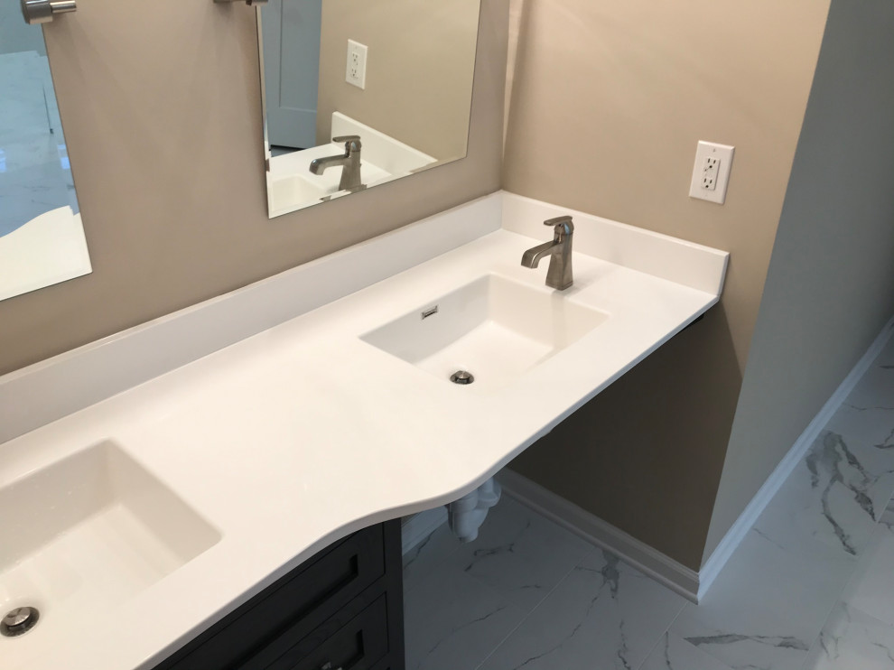 Bathroom - large craftsman master white tile and porcelain tile porcelain tile, white floor and double-sink bathroom idea in Indianapolis with shaker cabinets, black cabinets, a bidet, beige walls, an integrated sink, quartz countertops, white countertops and a built-in vanity