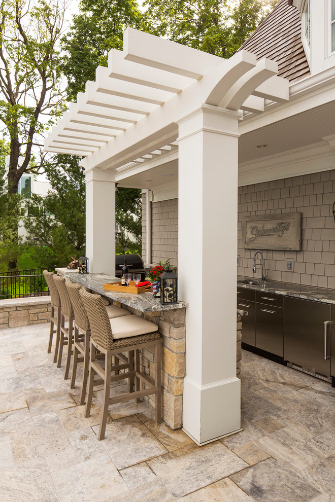 Inspiration for a large traditional backyard patio in Minneapolis with a pergola.
