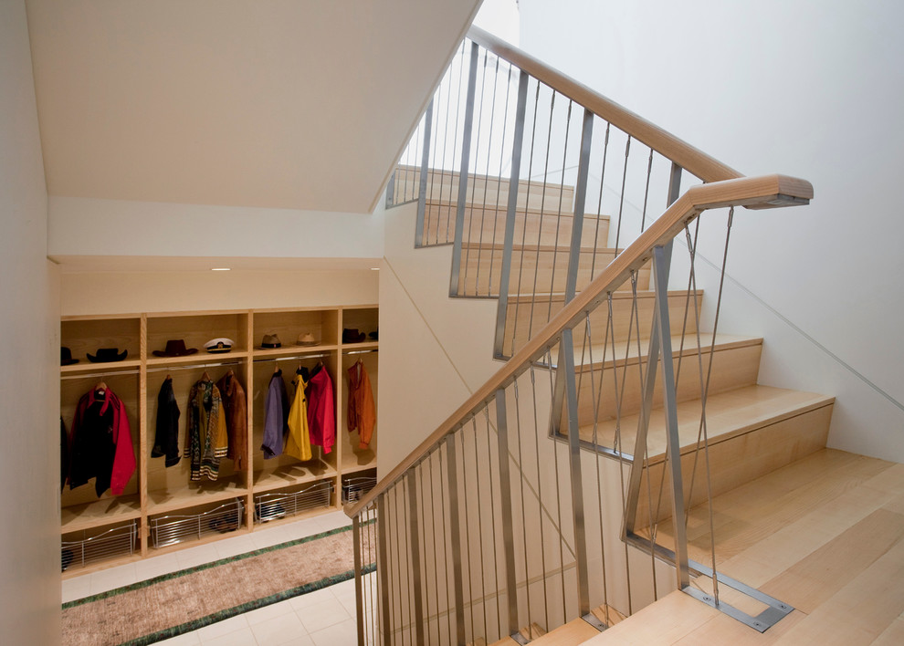 This is an example of a large contemporary gender-neutral walk-in wardrobe in Boston with open cabinets, light wood cabinets and ceramic floors.