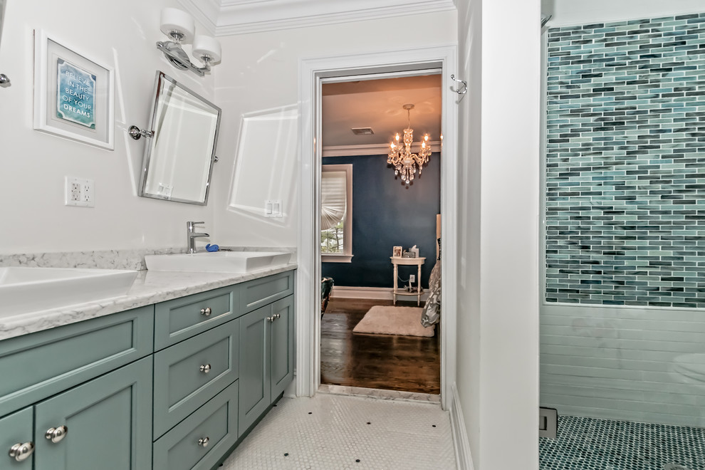 This is an example of a large modern master bathroom in New York with recessed-panel cabinets, green cabinets, an alcove shower, green tile, ceramic tile, white walls, ceramic floors, a vessel sink and granite benchtops.