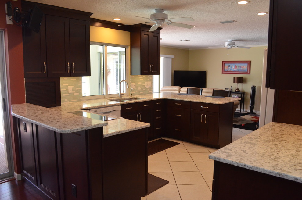 Eat-in kitchen - mid-sized transitional u-shaped ceramic tile eat-in kitchen idea in Tampa with a double-bowl sink, dark wood cabinets, multicolored backsplash, matchstick tile backsplash, stainless steel appliances, shaker cabinets, quartz countertops and two islands