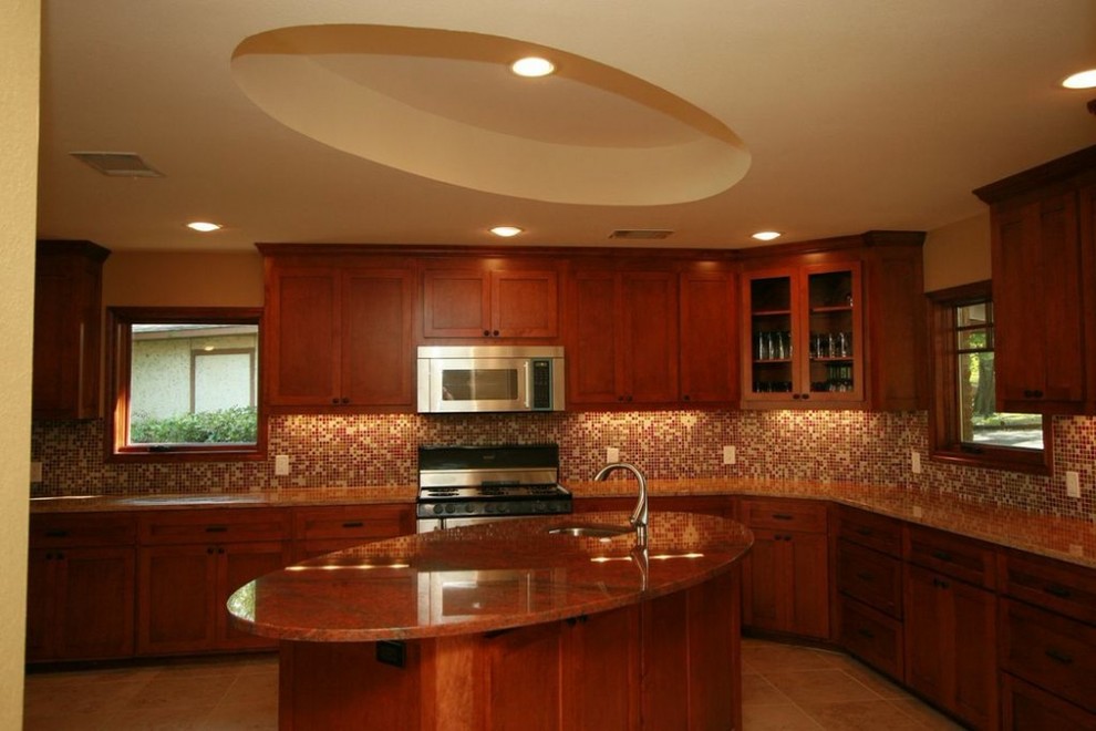Photo of a large traditional u-shaped kitchen in Dallas with a single-bowl sink, shaker cabinets, dark wood cabinets, granite benchtops, multi-coloured splashback, mosaic tile splashback, limestone floors and with island.