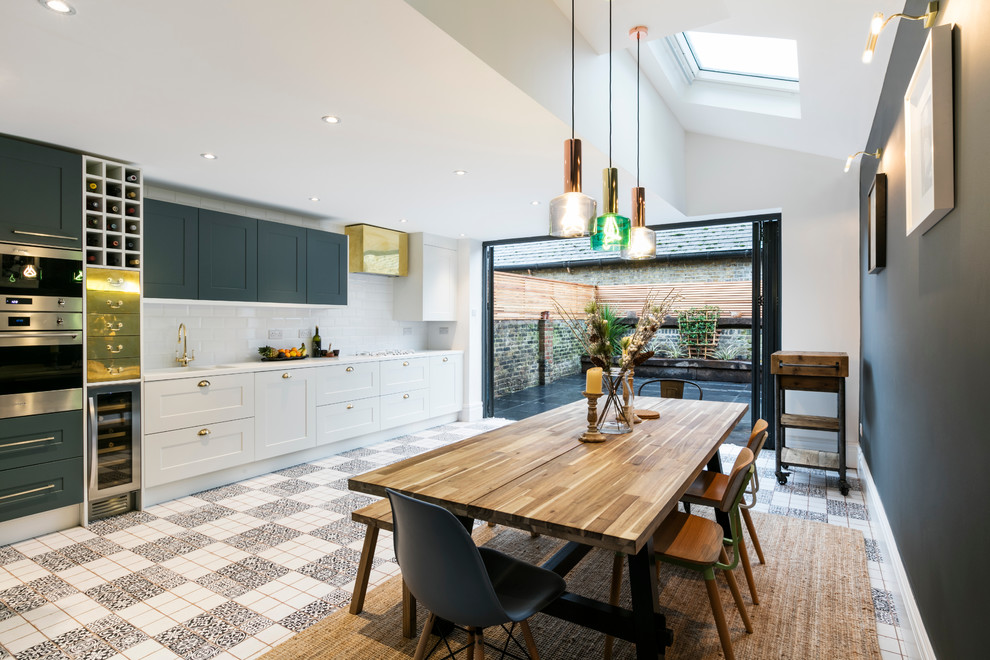Transitional kitchen/dining combo in London.