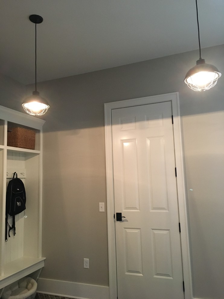 Inspiration for a small transitional dark wood floor and brown floor mudroom remodel with gray walls