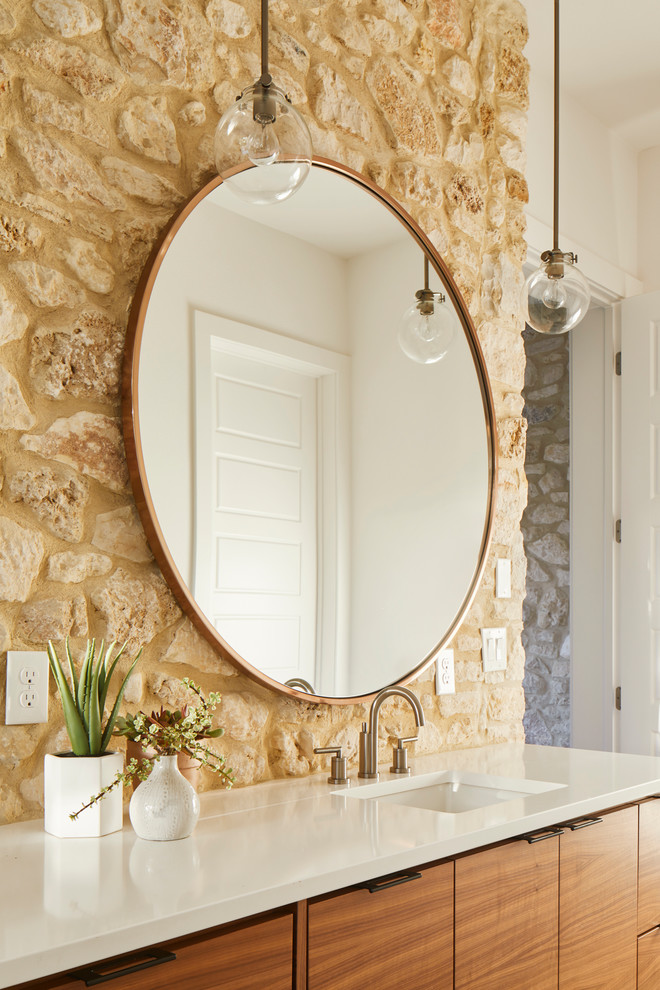 Inspiration for a large modern master bathroom in Austin with flat-panel cabinets, medium wood cabinets, a freestanding tub, a curbless shower, a one-piece toilet, beige tile, stone tile, white walls, concrete floors, an undermount sink, engineered quartz benchtops, grey floor, a hinged shower door and white benchtops.