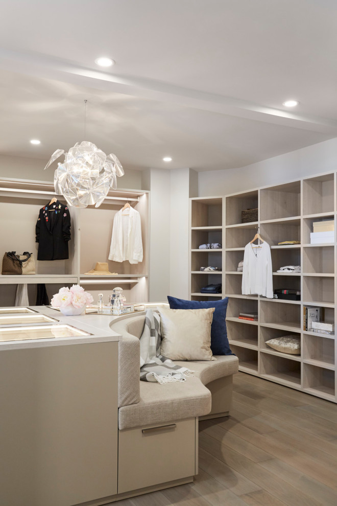 Example of a large beach style women's walk-in closet design in Orange County