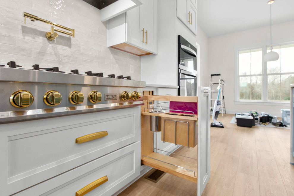 Inspiration for a large transitional l-shaped open concept kitchen remodel in Richmond with a farmhouse sink, recessed-panel cabinets, quartz countertops, white backsplash, stainless steel appliances, an island and white countertops