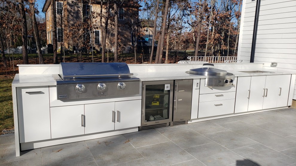 Photo of a large contemporary courtyard patio in New York with an outdoor kitchen.
