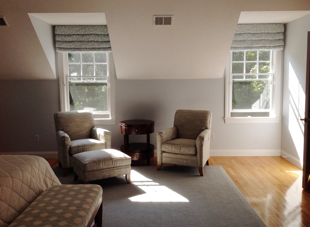 Example of a large transitional master medium tone wood floor bedroom design in Boston with blue walls and no fireplace