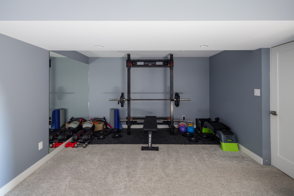 Inspiration for a small contemporary home weight room in Vancouver with blue walls, carpet and beige floor.