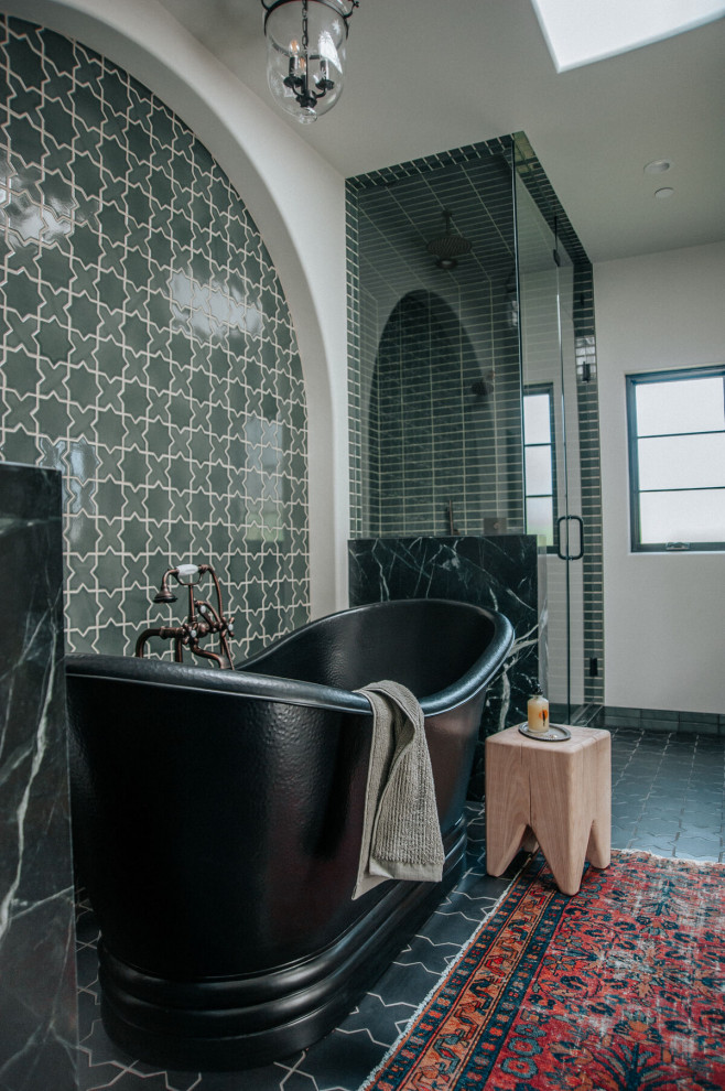 This is an example of a large bohemian ensuite bathroom in Los Angeles with a freestanding bath, a corner shower, green tiles, ceramic tiles, ceramic flooring, green floors and a hinged door.
