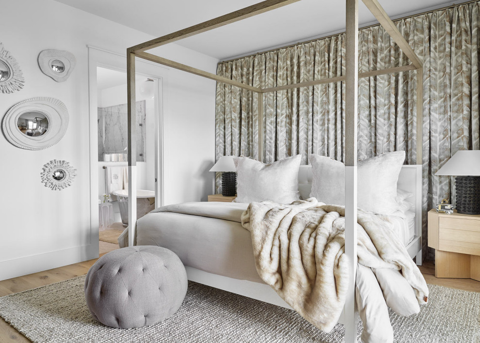 Beach Bungalow - Inspiration for a large coastal master light wood floor and beige floor bedroom remodel in Houston with white walls and no fireplace