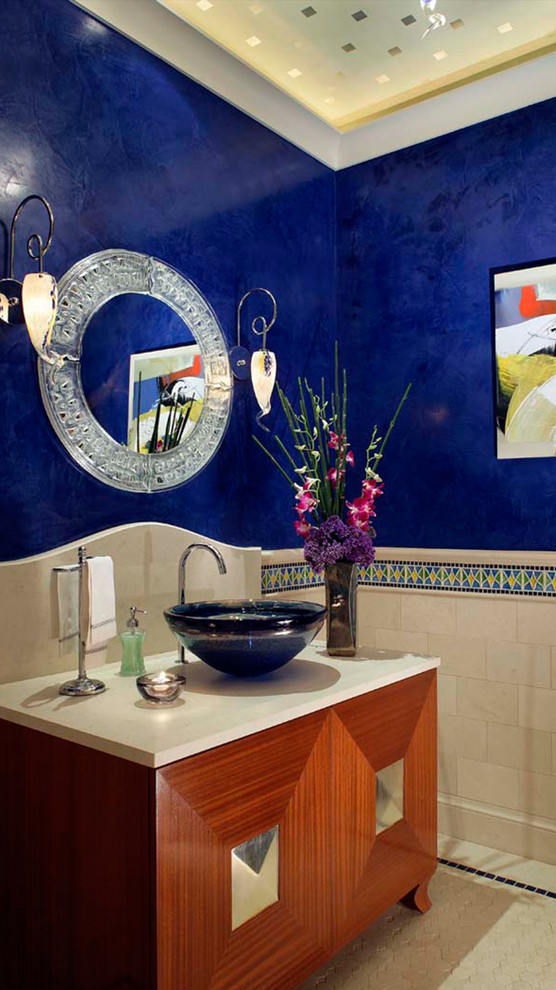 Photo of a mid-sized transitional powder room in Orange County with raised-panel cabinets, medium wood cabinets, multi-coloured tile, mosaic tile, blue walls, ceramic floors, a vessel sink, concrete benchtops and white floor.