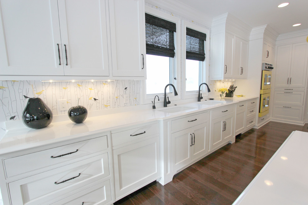 Photo of an expansive transitional galley eat-in kitchen in Cleveland with an undermount sink, beaded inset cabinets, white cabinets, quartz benchtops, multi-coloured splashback, coloured appliances, medium hardwood floors and multiple islands.