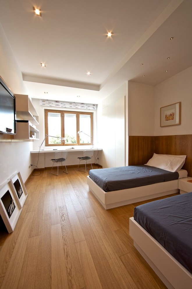 Mid-sized contemporary bedroom in Other with white walls and light hardwood floors.
