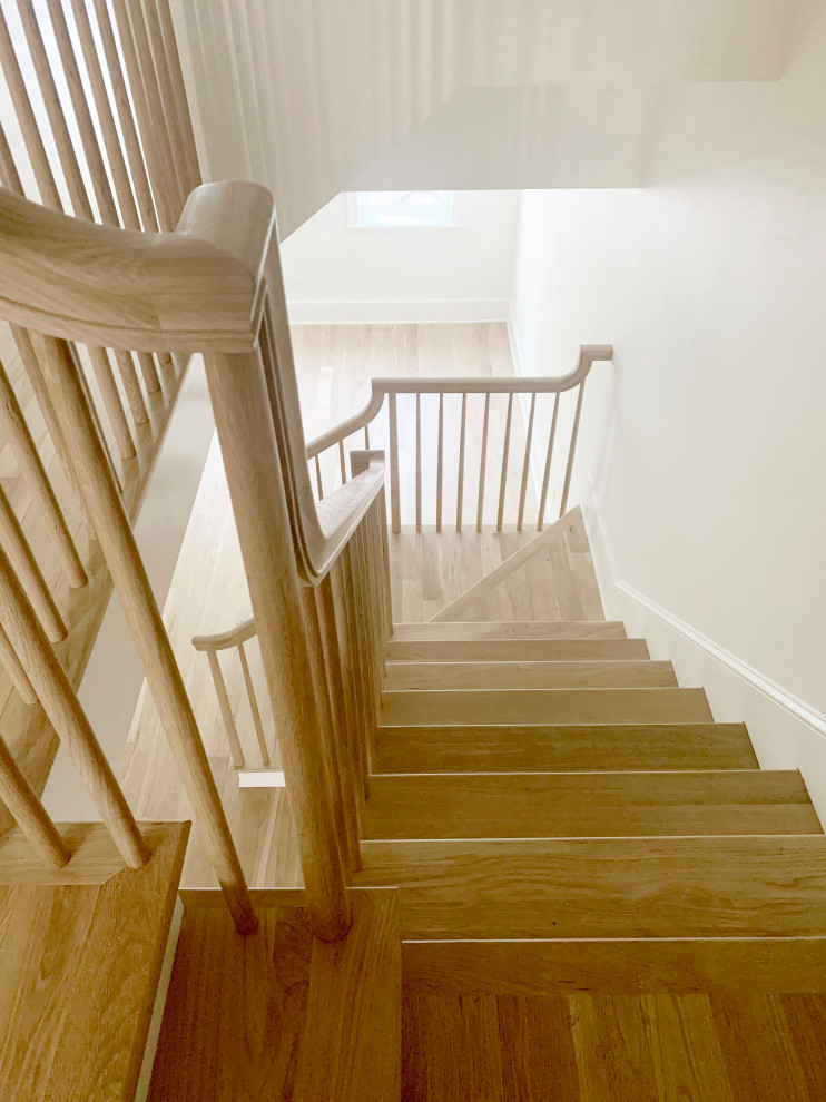 Photo of a small classic wood l-shaped wood railing staircase in Philadelphia with wood risers.