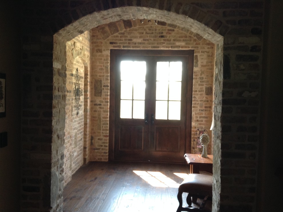 Entry hall - mid-sized rustic dark wood floor entry hall idea with red walls and a dark wood front door