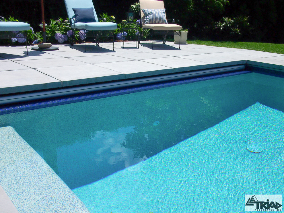 Design ideas for a small contemporary backyard rectangular pool in Boston with concrete pavers and a hot tub.