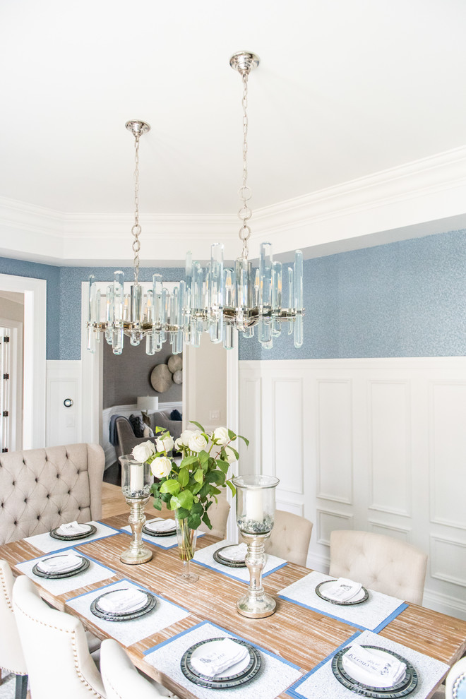 Large transitional medium tone wood floor and brown floor enclosed dining room photo in Toronto with blue walls and no fireplace