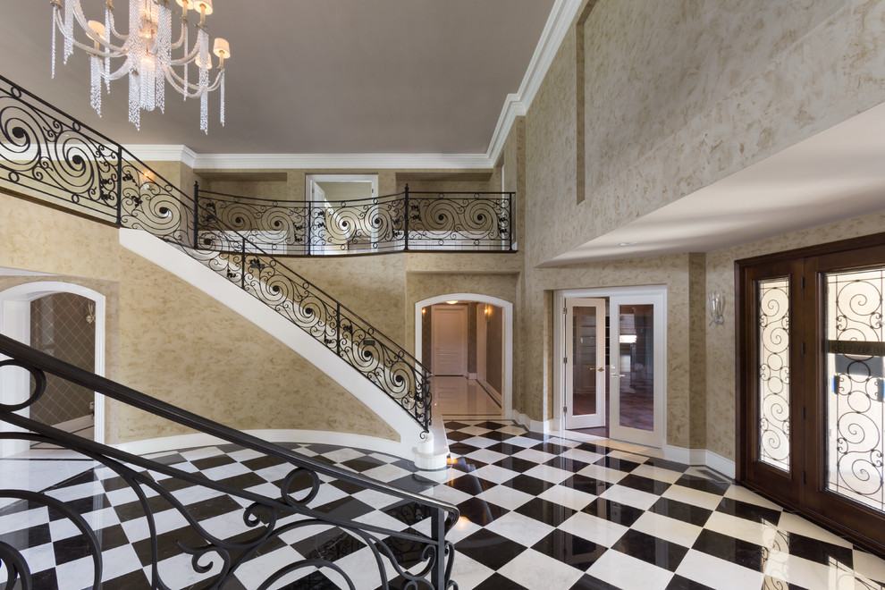 Photo of an expansive transitional foyer in San Francisco with beige walls and marble floors.