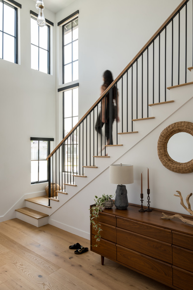 Huge beach style wooden straight mixed material railing staircase photo in Los Angeles with wooden risers