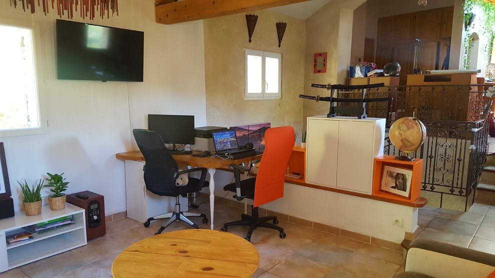 This is an example of a small asian study room in Marseille with white walls, ceramic floors, no fireplace, a freestanding desk and beige floor.