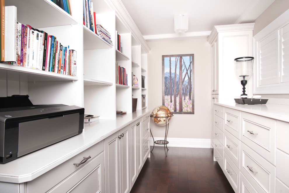 Mid-sized traditional craft room in Edmonton with white walls, dark hardwood floors and a built-in desk.