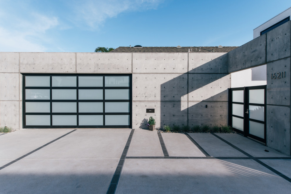 Photo of a large industrial two-storey concrete grey house exterior in Orange County with a flat roof.