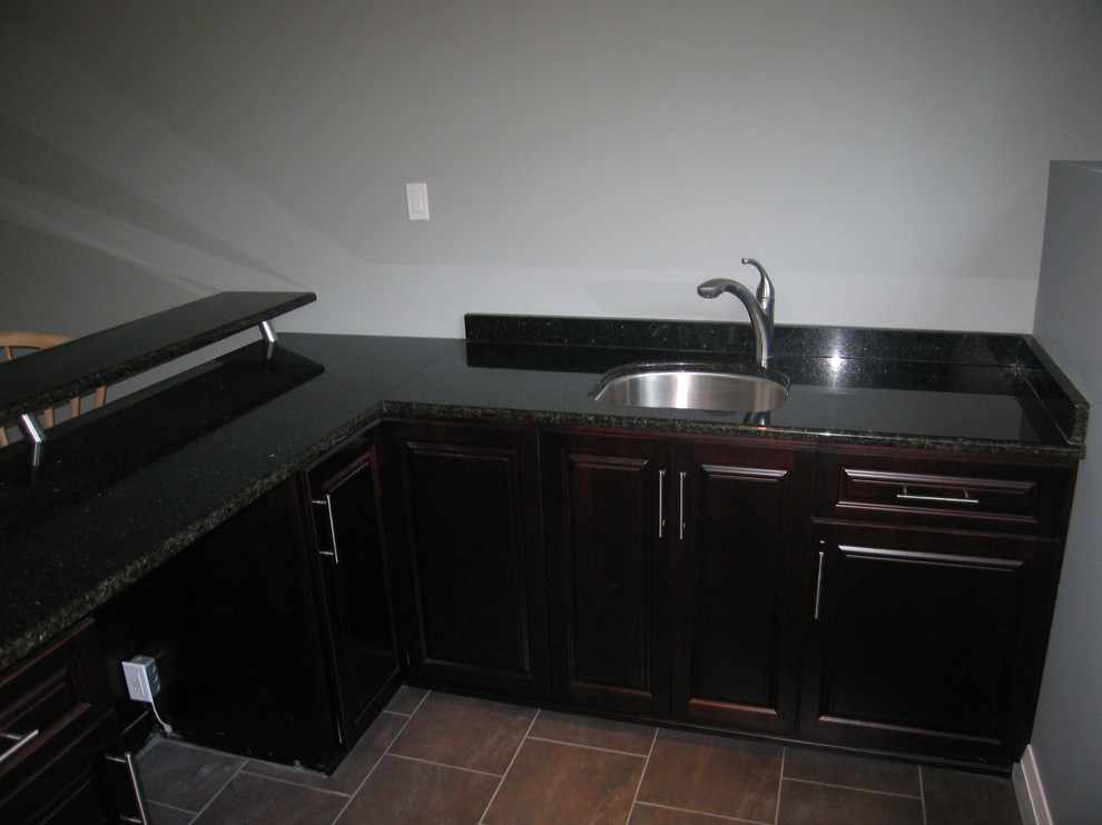 Inspiration for a mid-sized contemporary u-shaped kitchen remodel with gray walls, a single-bowl sink, raised-panel cabinets, dark wood cabinets, granite countertops, stainless steel appliances and no island