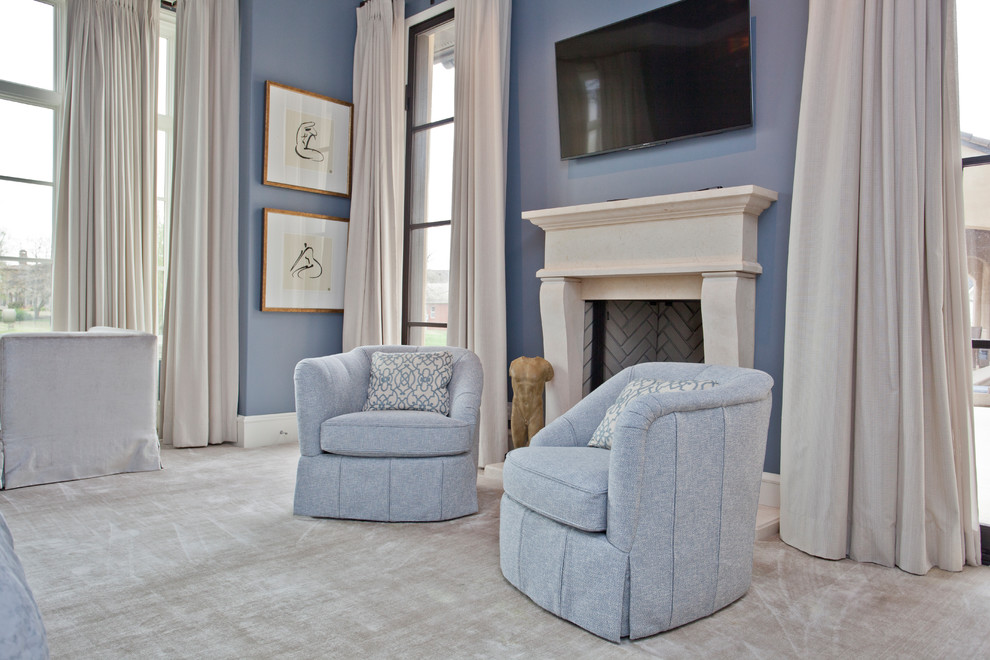 Photo of a large transitional master bedroom in Other with carpet, a standard fireplace and a stone fireplace surround.