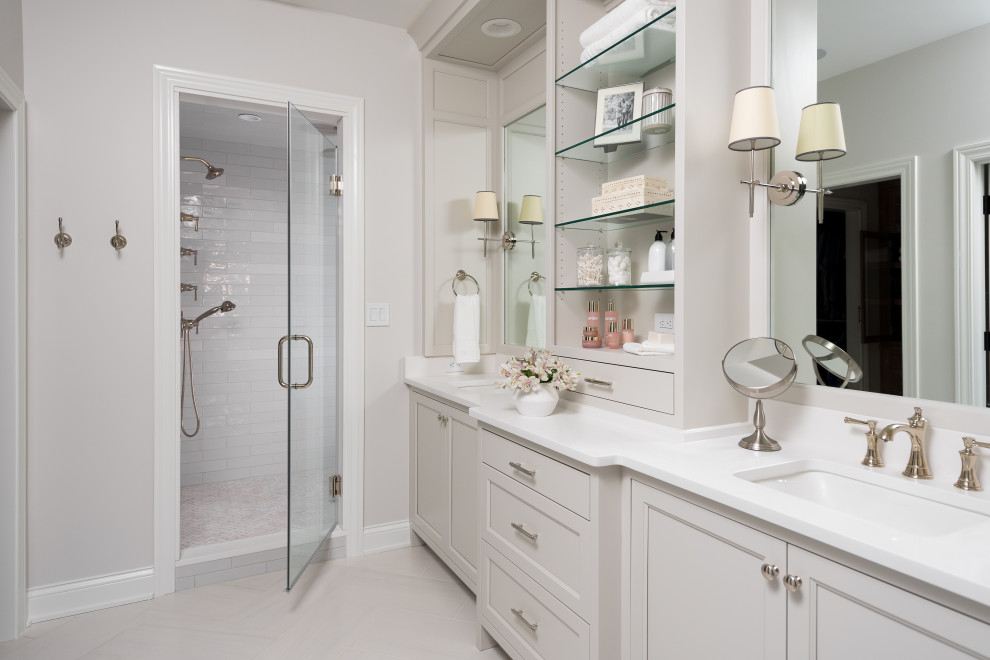Transitional white tile gray floor and double-sink alcove shower photo in Indianapolis with recessed-panel cabinets, white cabinets, white walls, an undermount sink, a hinged shower door, white countertops and a built-in vanity