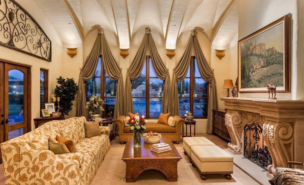 This is an example of an expansive traditional formal enclosed living room in Phoenix with beige walls, carpet, a standard fireplace, a stone fireplace surround and no tv.