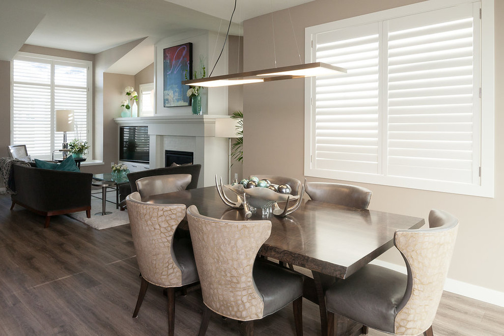 Kitchen/dining room combo - mid-sized transitional dark wood floor and brown floor kitchen/dining room combo idea in Minneapolis with beige walls, a standard fireplace and a brick fireplace